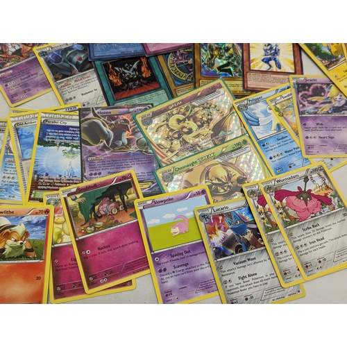 332 - A collection of Pokémon and Yu-Gi-Oh! game cards, in Pokémon tin.