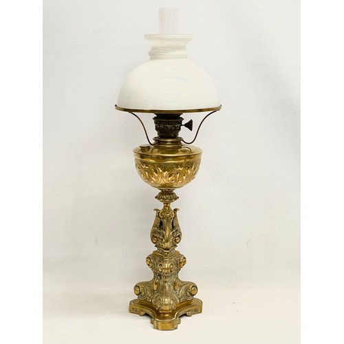 131 - A tall Victorian ornate brass oil lamp. 77cm