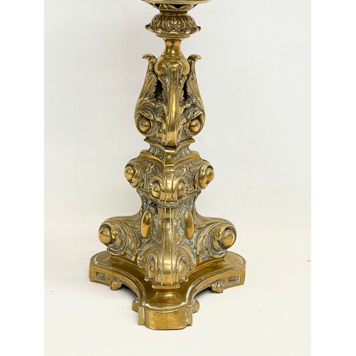 131 - A tall Victorian ornate brass oil lamp. 77cm