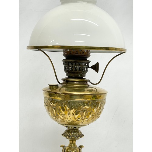 131 - A tall Victorian ornate brass oil lamp. 77cm