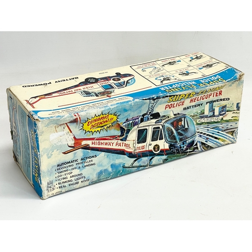 73 - A vintage Super Flying Police Helicopter in original box. Made in Japan. Box measures 37x13x13cm