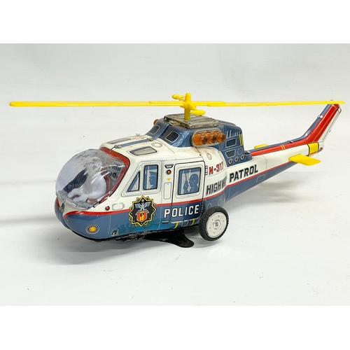 73 - A vintage Super Flying Police Helicopter in original box. Made in Japan. Box measures 37x13x13cm