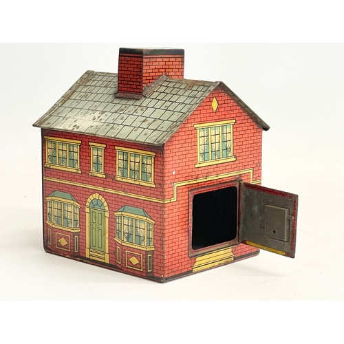 90 - An early 20th century tin plate money box house. 12x14cm