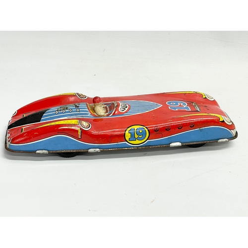 94 - A vintage British Made tin plate racing car with driver. 28.5cm