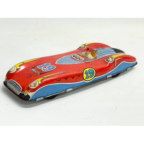 94 - A vintage British Made tin plate racing car with driver. 28.5cm