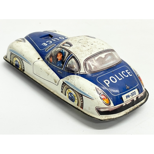 95 - A vintage German Made tin plate police car. 21cm