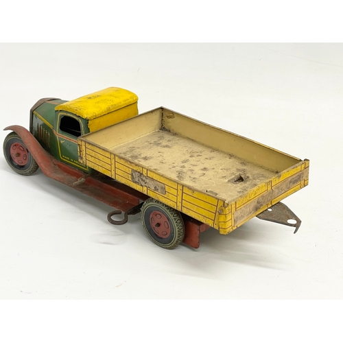 101 - A vintage English Made tin plate tipping truck. 31cm