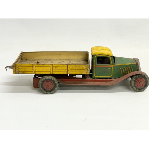 101 - A vintage English Made tin plate tipping truck. 31cm