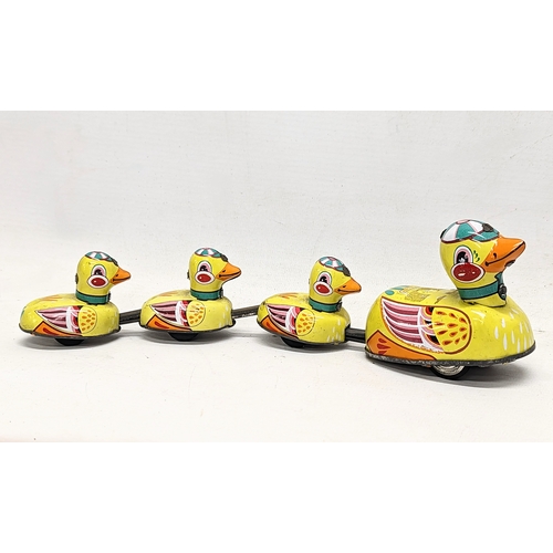 104 - A vintage wind-up tin toy, mother duck and ducklings. 29cm
