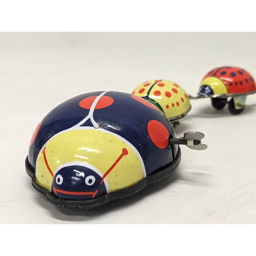 105 - A vintage wind-up ladybird tin toy. 31cm