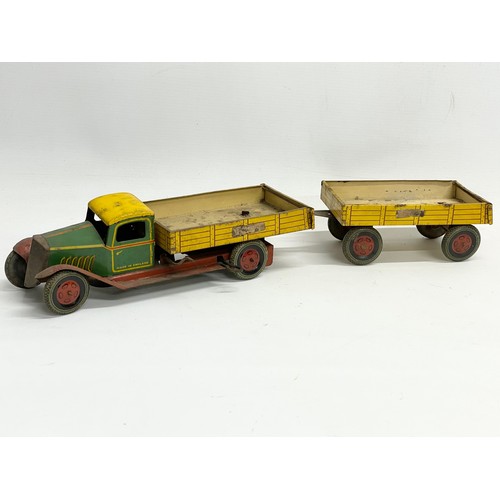 101 - A vintage English Made tin plate tipping truck. 31cm