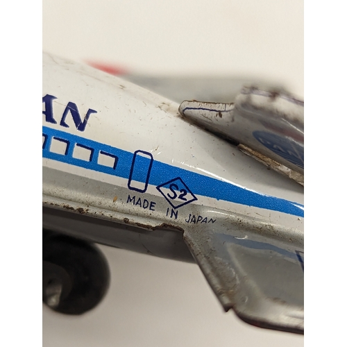 112 - A vintage Sakai Seisakusho Ltd (S2 Japan) tin toy Pan American N900PA plane, with other vintage wind... 