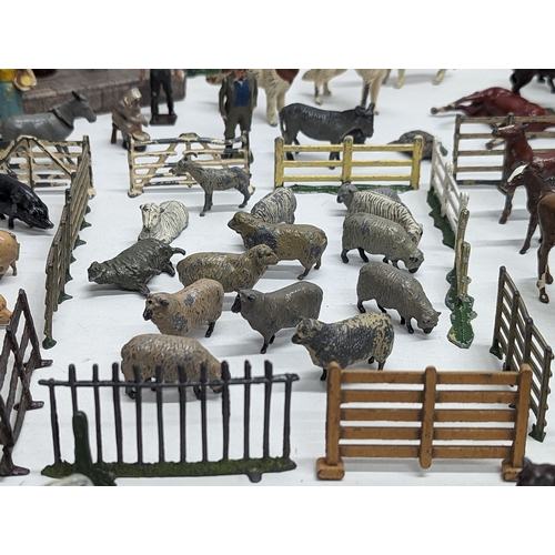 127 - A large collection of vintage Britains led animals, etc. Including Blacksmiths, Racehorses, farm yar... 