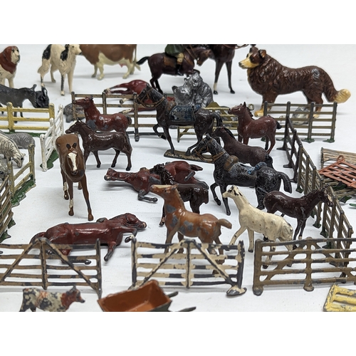 127 - A large collection of vintage Britains led animals, etc. Including Blacksmiths, Racehorses, farm yar... 