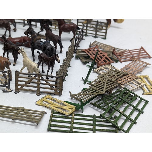 127 - A large collection of vintage Britains led animals, etc. Including Blacksmiths, Racehorses, farm yar... 