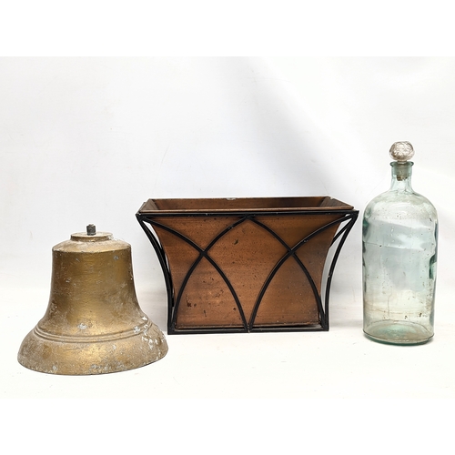 380 - A sundry lot including a large vintage glass bottle with stopper, vintage a copper planter, and cast... 