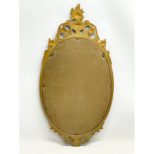 278 - An ornate gilt frame mirror. Plastic frame. 41x79cm