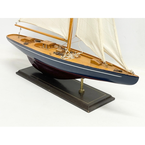 284 - A large model yacht on stand. 61x85cm