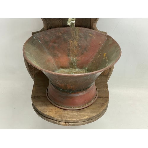 290 - A 19th century French wall mounted copper fountain. 96cm