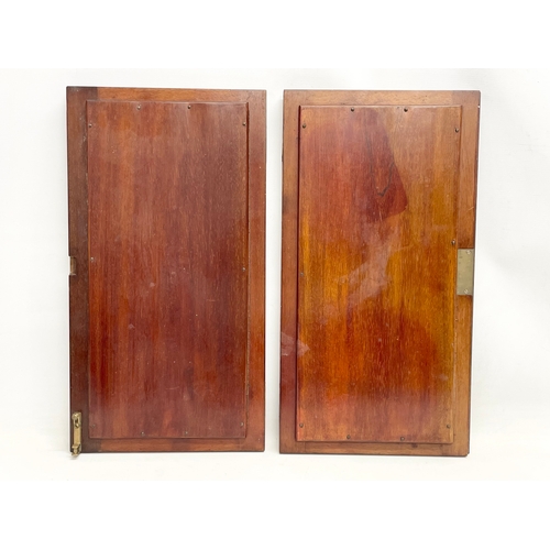 306 - A pair of Victorian mahogany cabinet doors with bevelled glass panels. 31x58cm