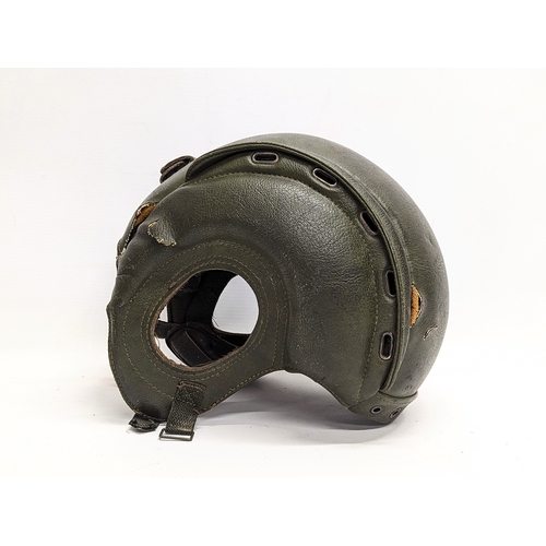 310 - A vintage American helmet with a vintage tanker helmet.