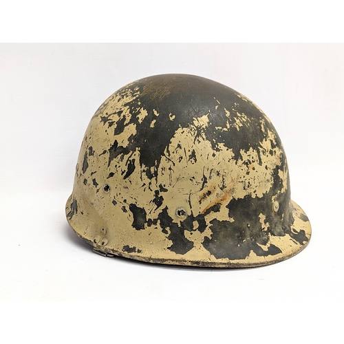 310 - A vintage American helmet with a vintage tanker helmet.