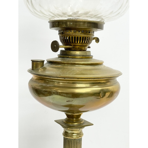 195R - A tall late Victorian brass double burner oil lamp. 70cm