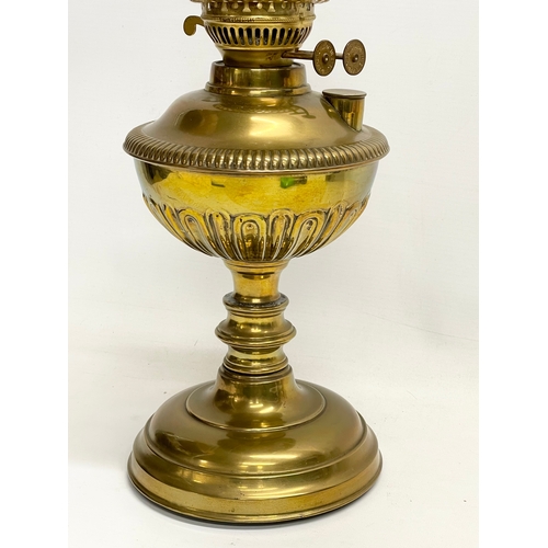 195S - A Victorian brass double burner oil lamp. 56cm