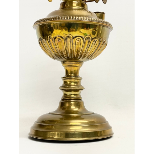 195S - A Victorian brass double burner oil lamp. 56cm