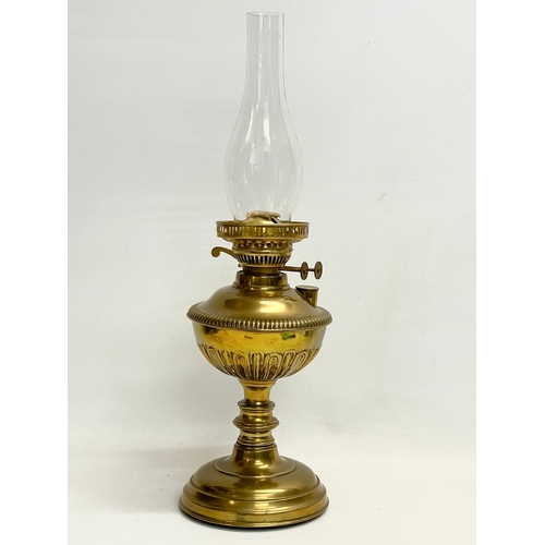 195S - A Victorian brass double burner oil lamp. 56cm