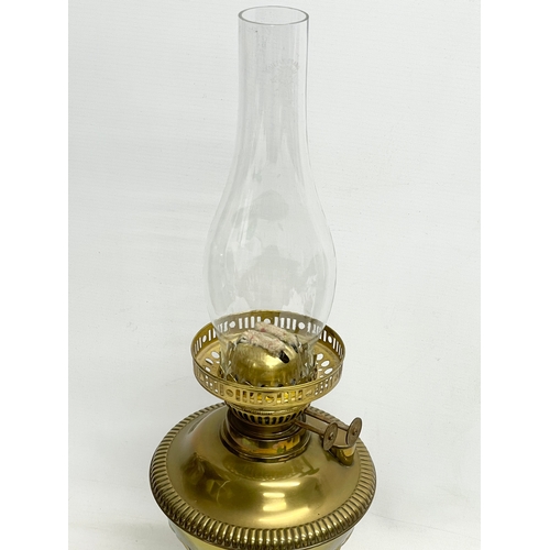 195S - A Victorian brass double burner oil lamp. 56cm