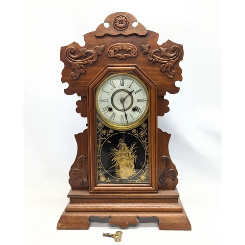 195X - A late 19th century American gingerbread clock with pendulum and key. 36x57.5cm