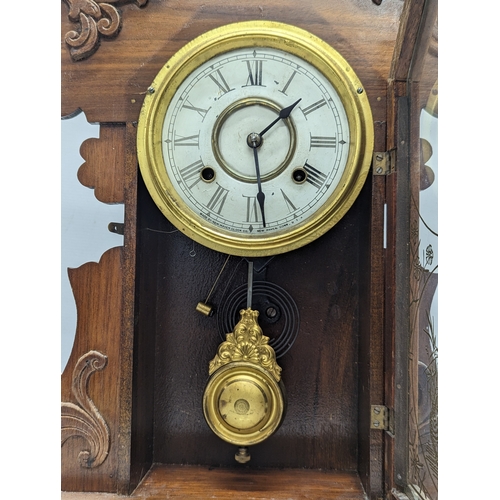 195X - A late 19th century American gingerbread clock with pendulum and key. 36x57.5cm