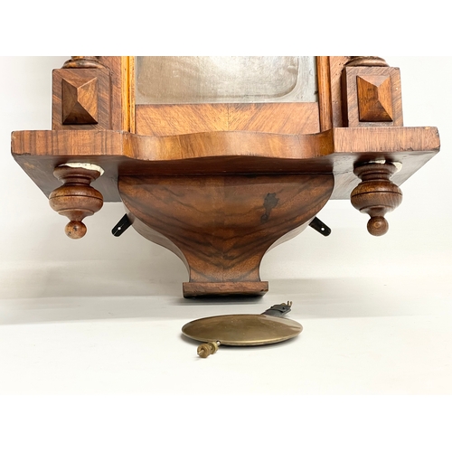 196D - A Victorian Walnut wall clock with pendulum. 70cm