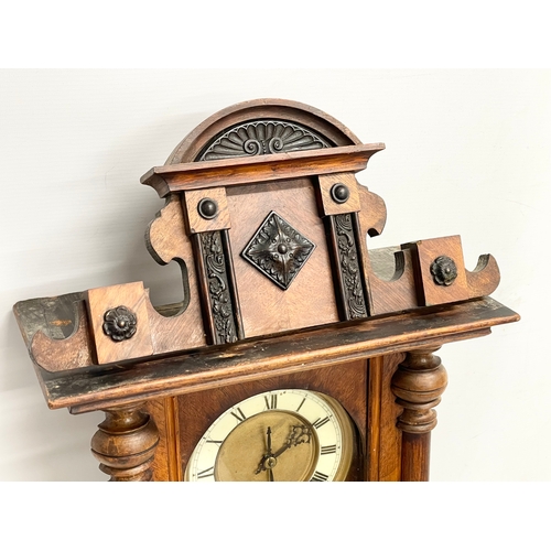 196D - A Victorian Walnut wall clock with pendulum. 70cm