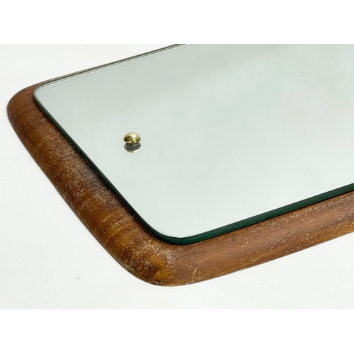 196I - A Mid Century teak framed mirror. 34x65cm