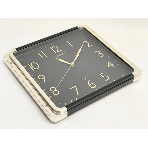 196K - A vintage bevelled mirror and a Seiko wall clock. Mirror measures 30x61cm. Clock measure 30cm