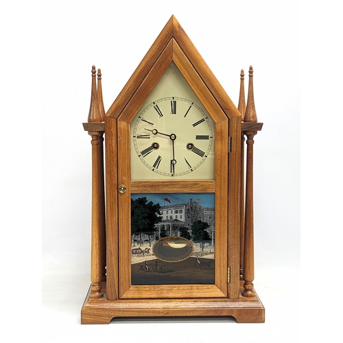 207C - A vintage neogothic style mantle clock, with key and pendulum. 29.5x48.5cm