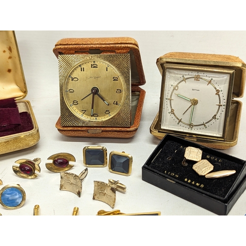 591Y - A sundry lot including vintage cufflinks, 2 vintage travel clocks by Jerger and Estyma, and brooches... 