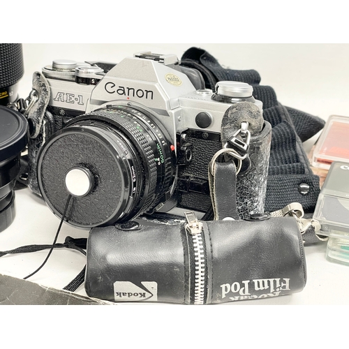 376A - A vintage Canon AE-1 camera with accessories.