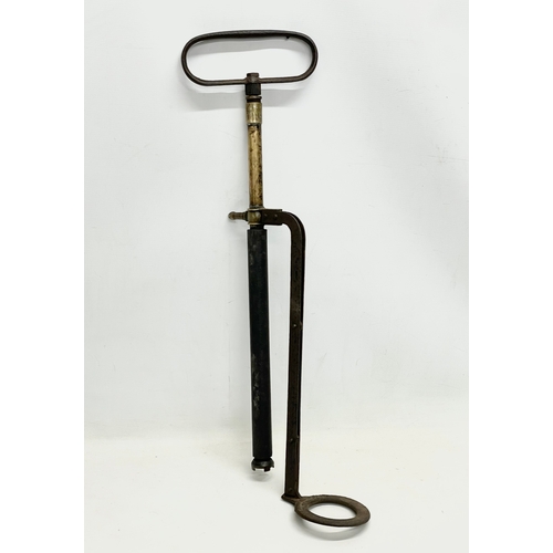 389I - A vintage Stirrup pump. 72cm