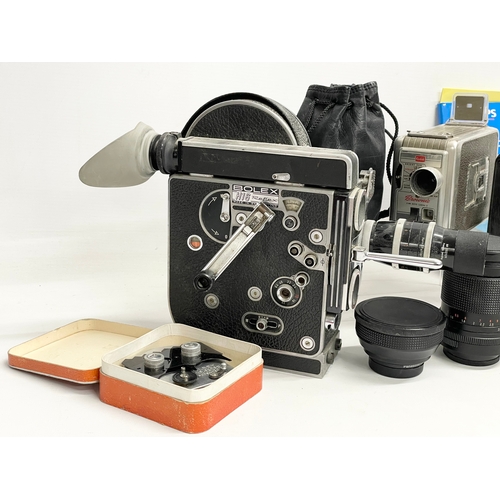 376C - A collection of vintage cameras. A Bolex H16 Reflex. A Kodak Brownie, lenses etc.