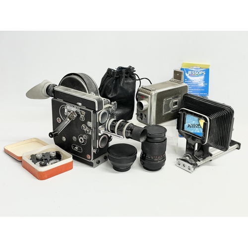 376C - A collection of vintage cameras. A Bolex H16 Reflex. A Kodak Brownie, lenses etc.