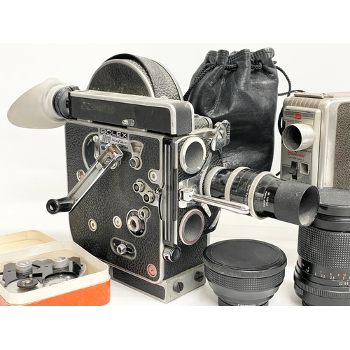 376C - A collection of vintage cameras. A Bolex H16 Reflex. A Kodak Brownie, lenses etc.