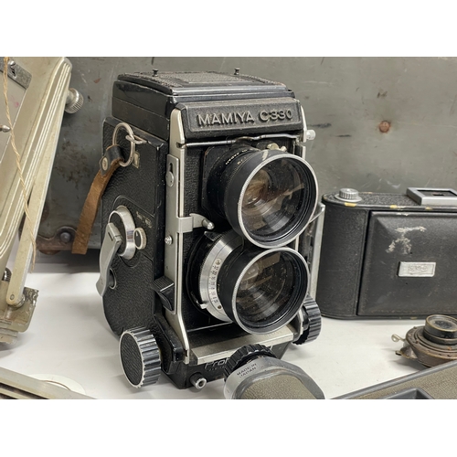 376D - A collection of vintage cameras. A Kodak Graphie View, a Mamiya C330, Ensign camera etc.