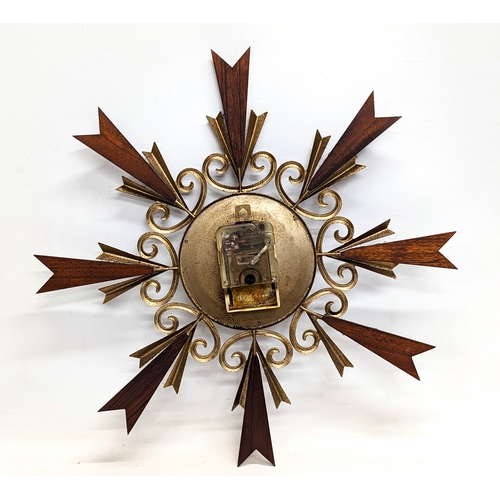 196Z - A Mid Century Paico teak and brass sunburst clock. 50cm