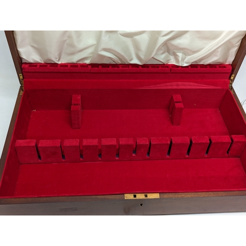 713 - A large mahogany cutlery case. 64x37x13cm