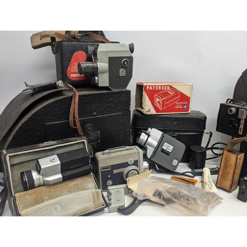 376Q - A large collection of vintage cameras including Sankyo, Eumig, Canon, etc