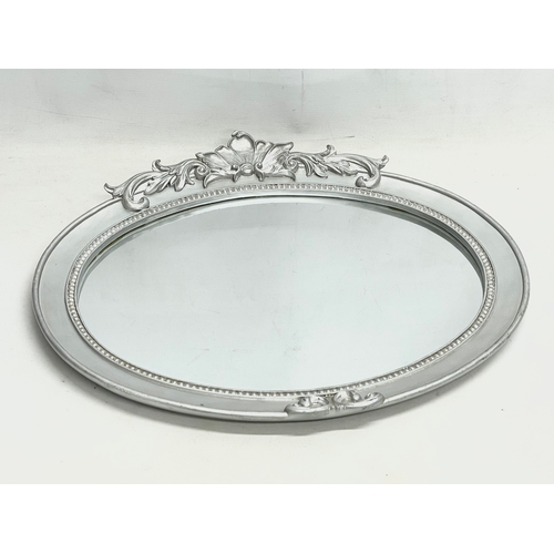 185U - An ornate framed mirror. 58x52cm