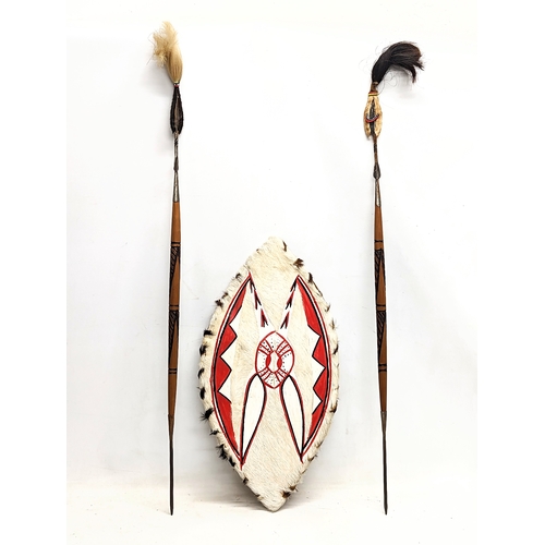 379K - An African style tribal shield and spears. Shield measures 29.5x58.5cm